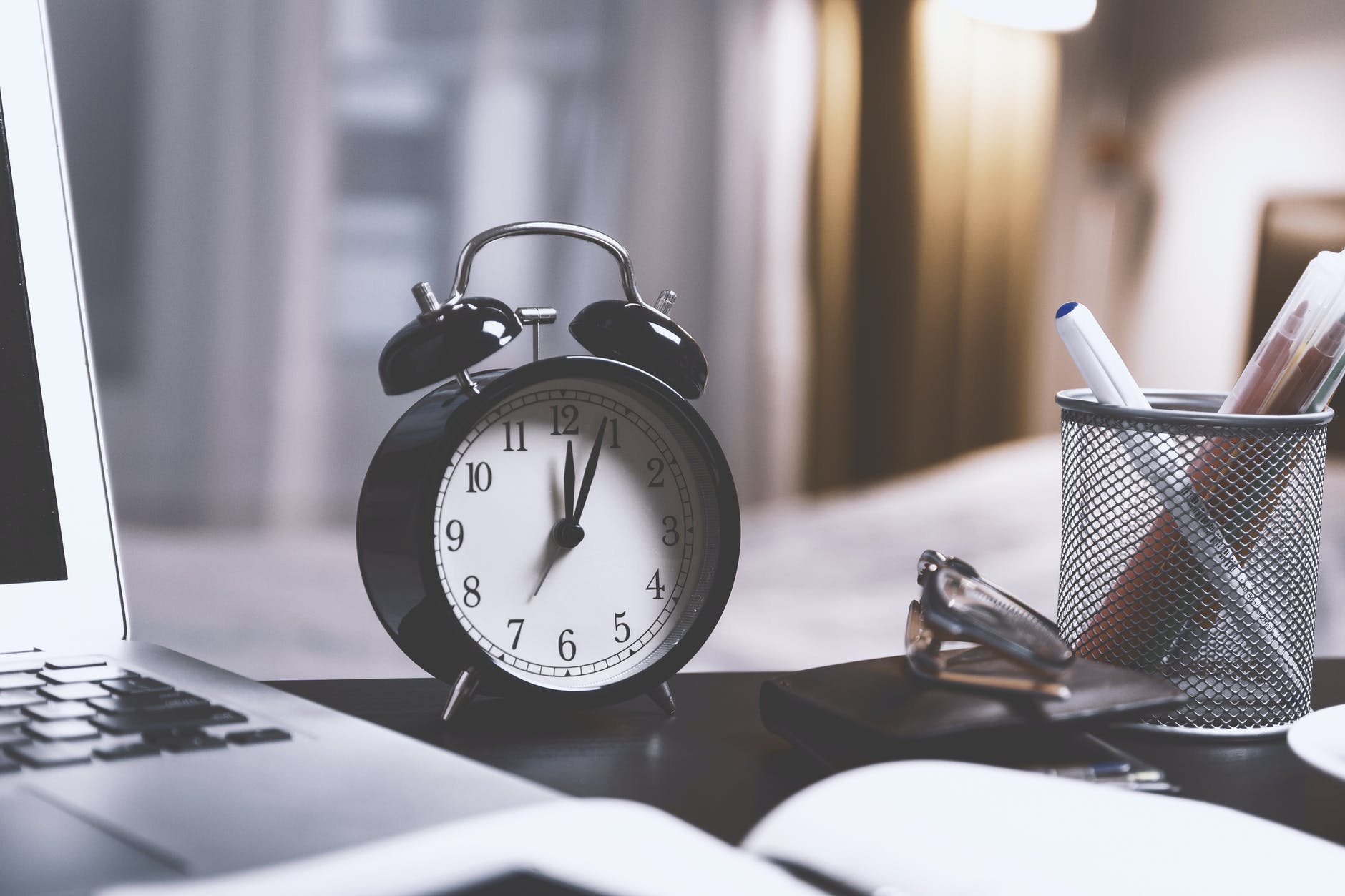 black twin bell alarm desk clock on table